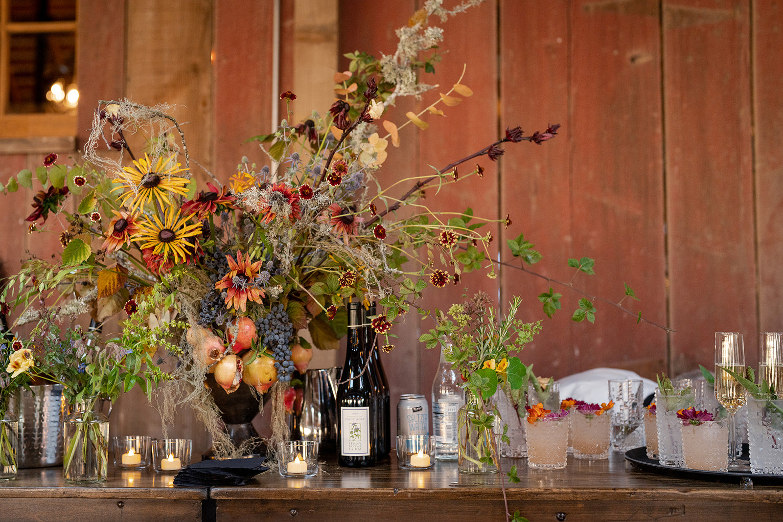 Show stopper bar arrangement featuring florals, grasses, and fruits from Front Porch Farm designed by Flower Porch in Healdsburg CA