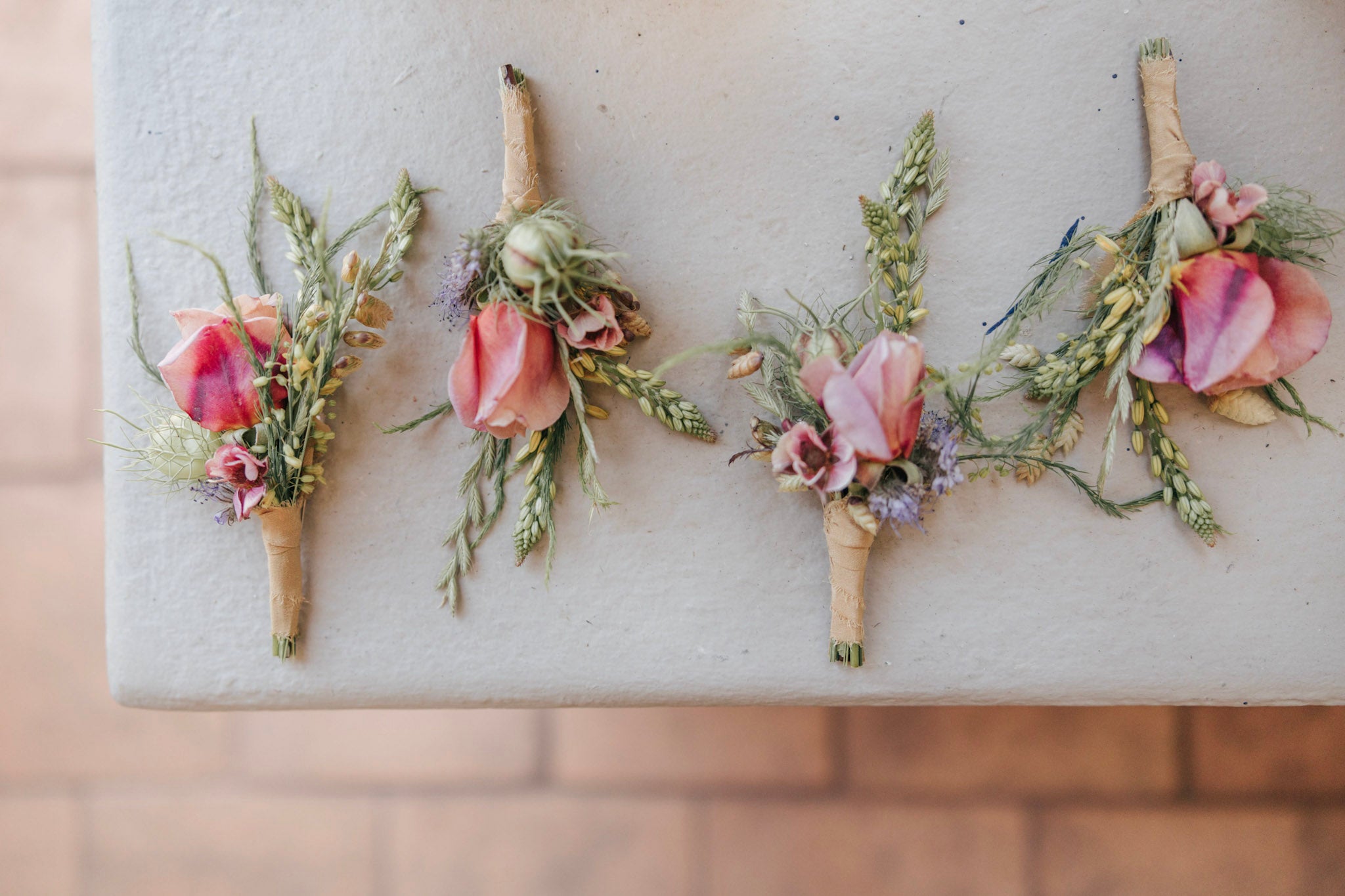 Four floral boutonnieres made at Flower Porch Healdsburg CA for a wedding at the Stavrand in Sonoma County.