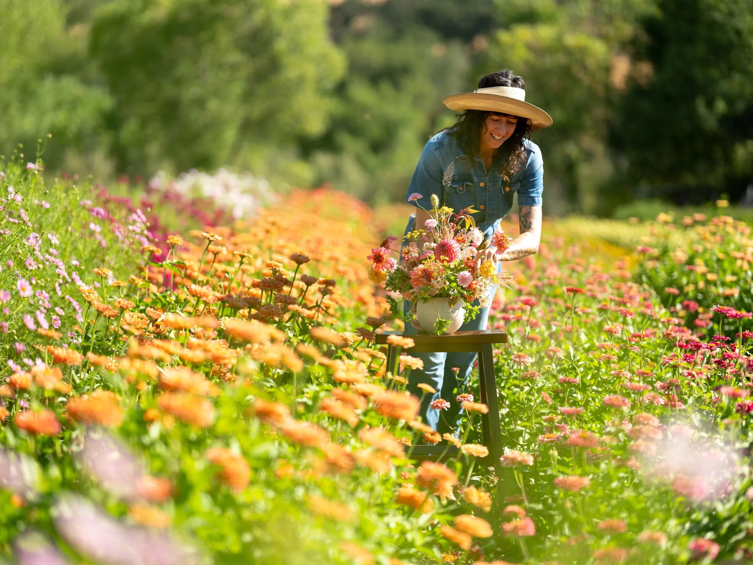Creative Director and floral designer at Flower porch arranging out in a flower field at Front Porch Farm.
