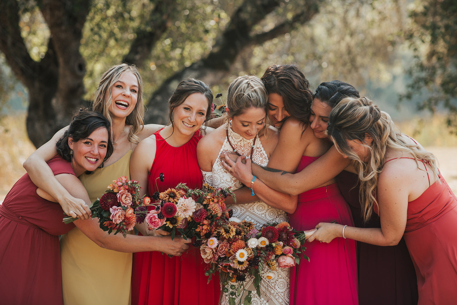 Bride and bridesmaids holding hand-tied bouquets in a rich moody and rich color palette designed by Flower Porch in Healdsburg CA.