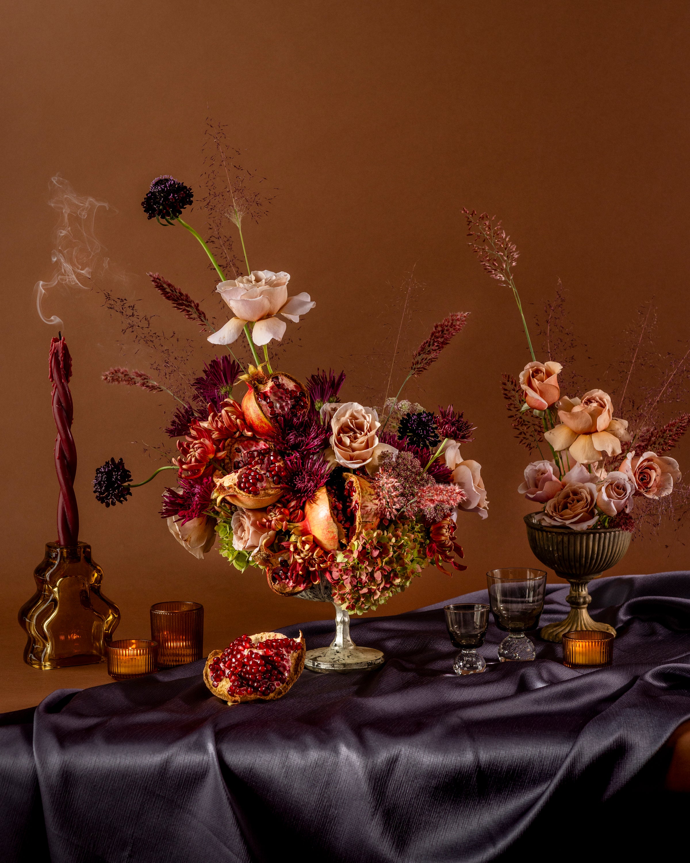 Elegant table setting with floral arrangements including seasonal fruit elements in the floral design at Flower Porch. Photographed by Nicola Parisi.