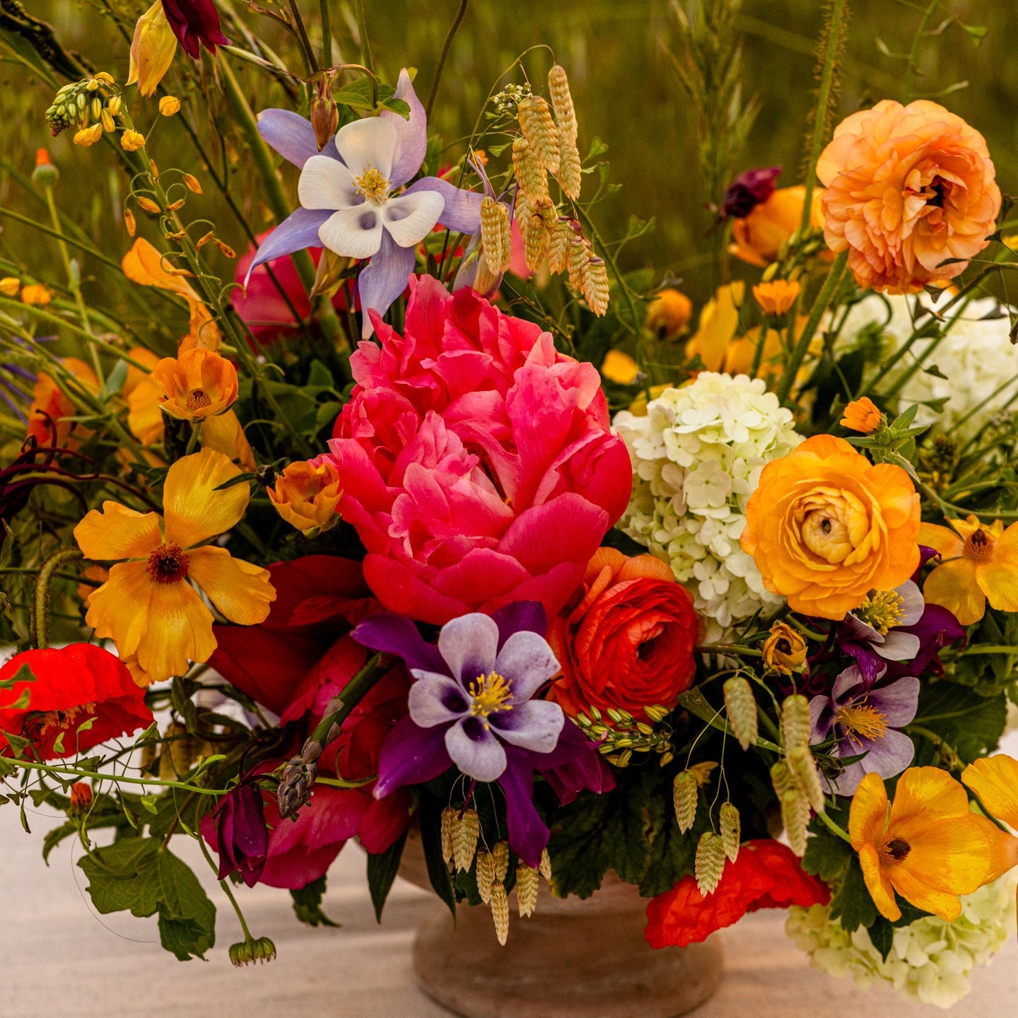 Bright and joyful floral arrangement featuring peonies, ranunculus, colombine grasses all grown organically at Front Porch Farm in Healdsburg CA