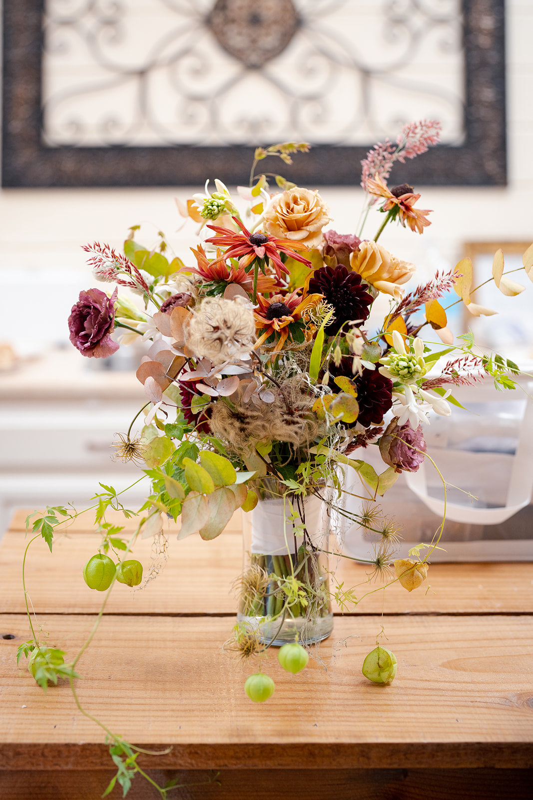 Hand-tied wedding bouquet in a deep rich color palette featuring organically grown flowers, grasses, and fruit grown at Front Porch Farm and designed by Flower Porch in Healdsburg CA